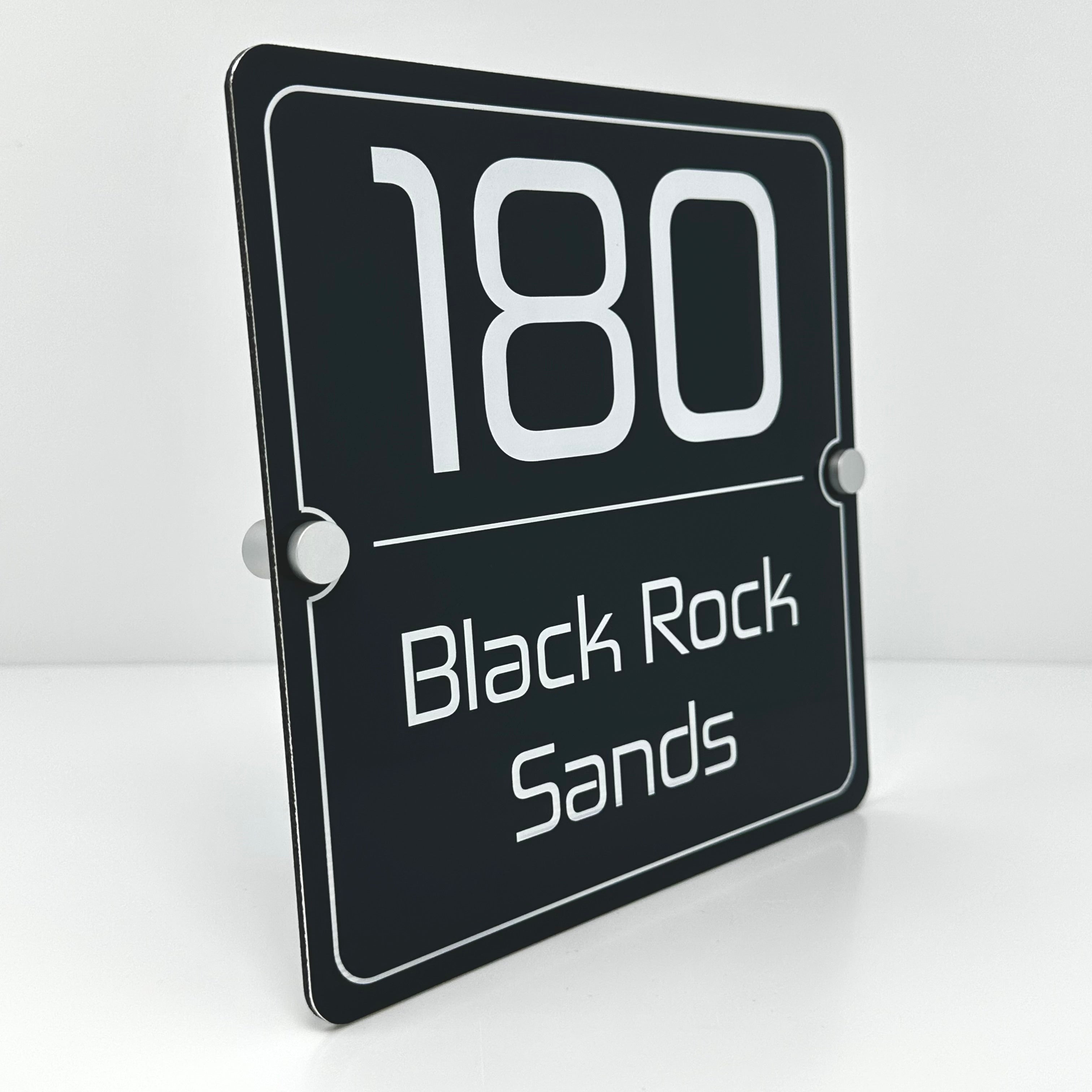 The Black Rock Sands Modern House Sign with a Anthracite Grey Panel and Satin Silver Stand Off Fixings ( Size - 20cm x 20cm )