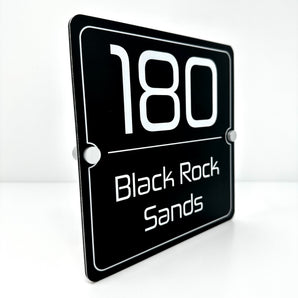 The Black Rock Sands Modern House Sign with a Brushed Black Panel and Satin Silver Stand Off Fixings ( Size - 20cm x 20cm )