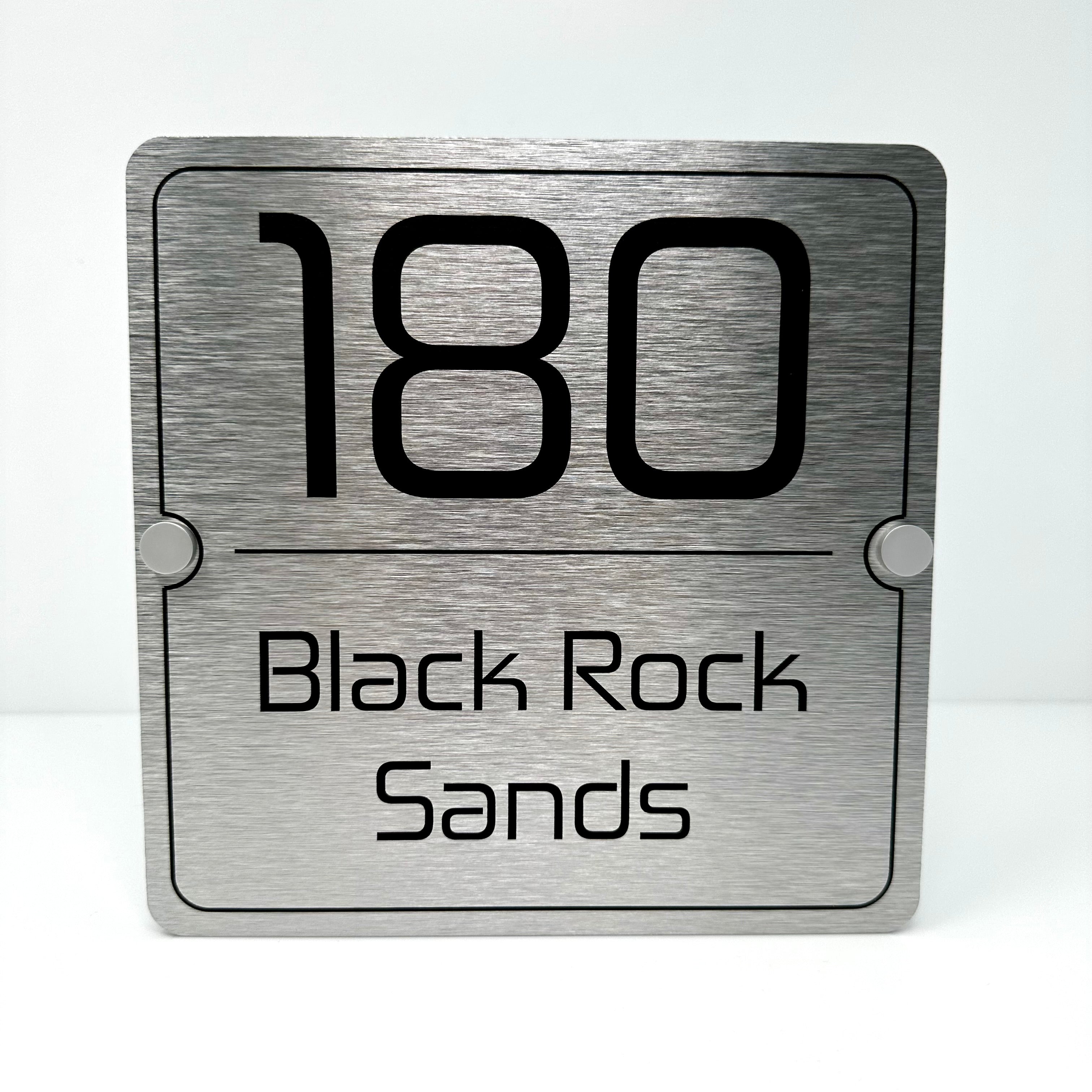 The Black Rock Sands Modern House Sign with a Brushed Silver Panel and Satin Silver Stand Off Fixings ( Size - 20cm x 20cm )