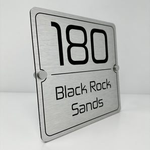 The Black Rock Sands Modern House Sign with a Brushed Silver Panel and Satin Silver Stand Off Fixings ( Size - 20cm x 20cm )