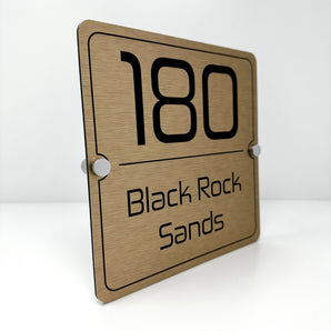 The Black Rock Sands Modern House Sign with a Brushed Brass Panel and Satin Silver Stand Off Fixings ( Size - 20cm x 20cm )