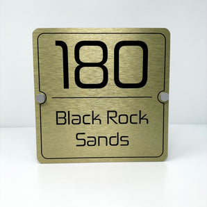 The Black Rock Sands Modern House Sign with a Brushed Gold Panel and Satin Silver Stand Off Fixings ( Size - 20cm x 20cm )