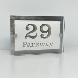 The Parkway Modern House Sign with Perspex Acrylic Front, Silver Rear Panel and Satin Silver Stand Off Fixings ( Size - 20cm x 14cm - WHITE BACKGROUND CLEAR TEXT )