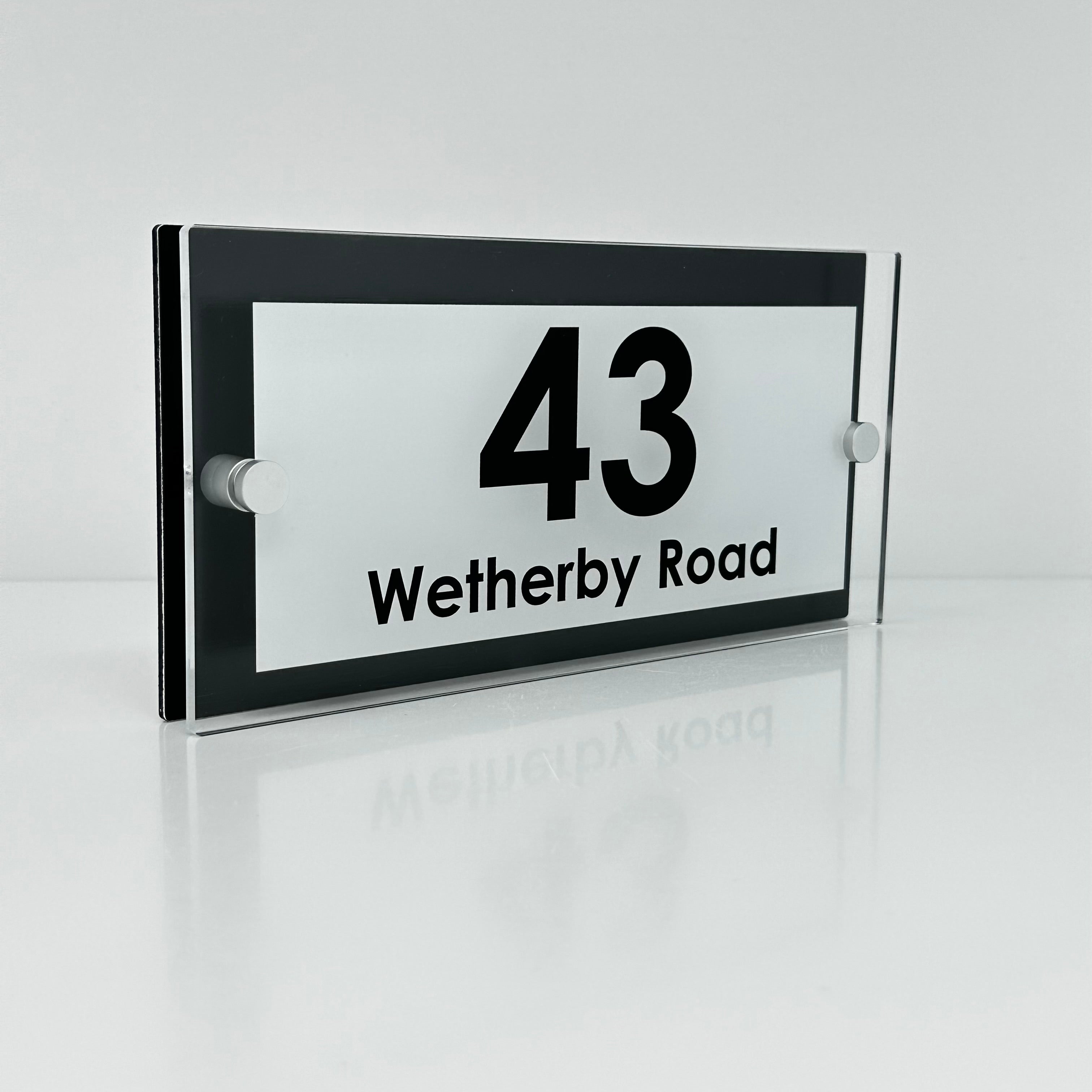 The Wetherby Modern House Sign with Perspex Acrylic Front, Black Rear Panel and Satin Silver Stand Off Fixings ( Size - 25cm x 12cm - WHITE BACKGROUND BLACK TEXT )