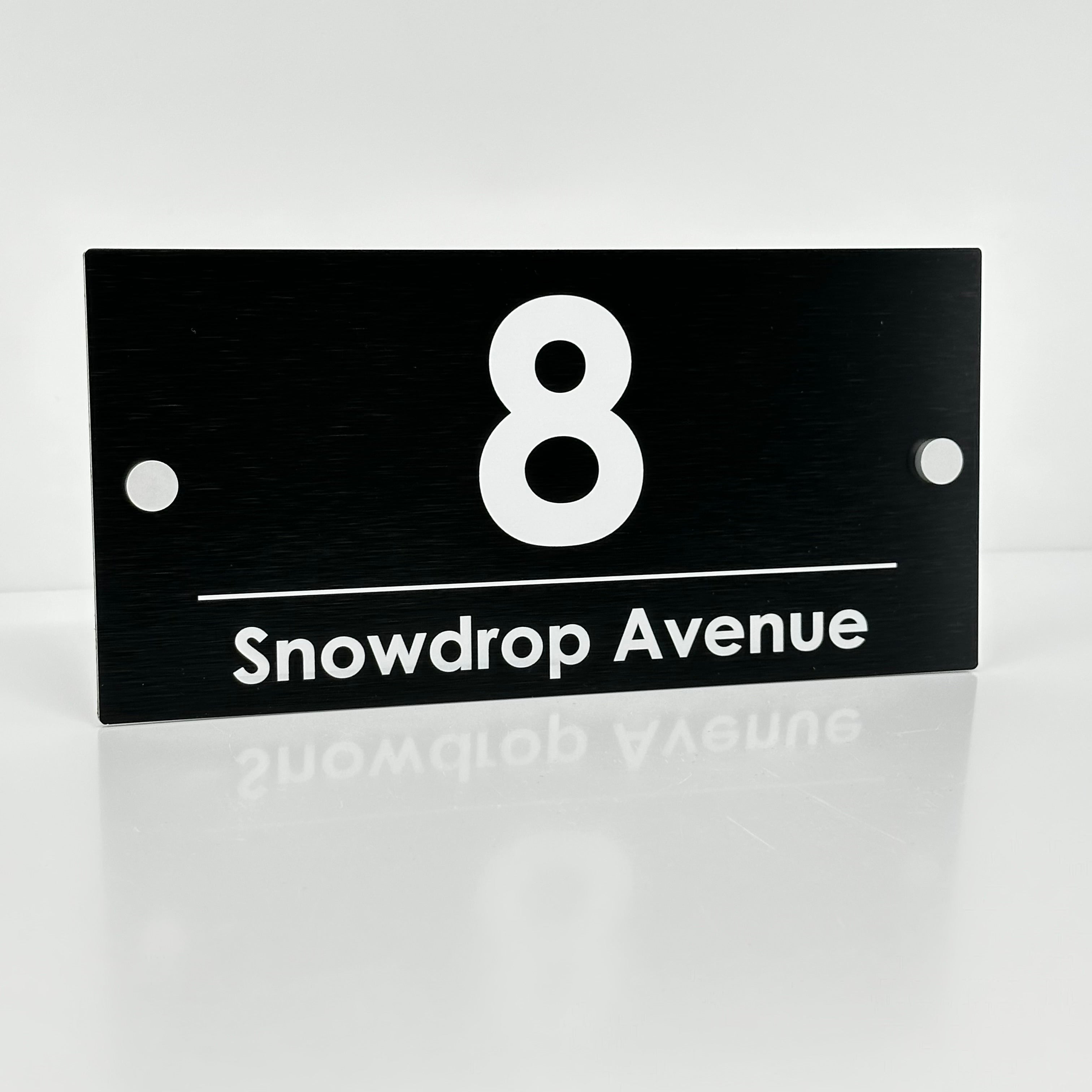 The Snowdrop Modern House Sign with a Brushed Black Panel and Satin Silver Stand Off Fixings ( Size - 25cm x 12cm )