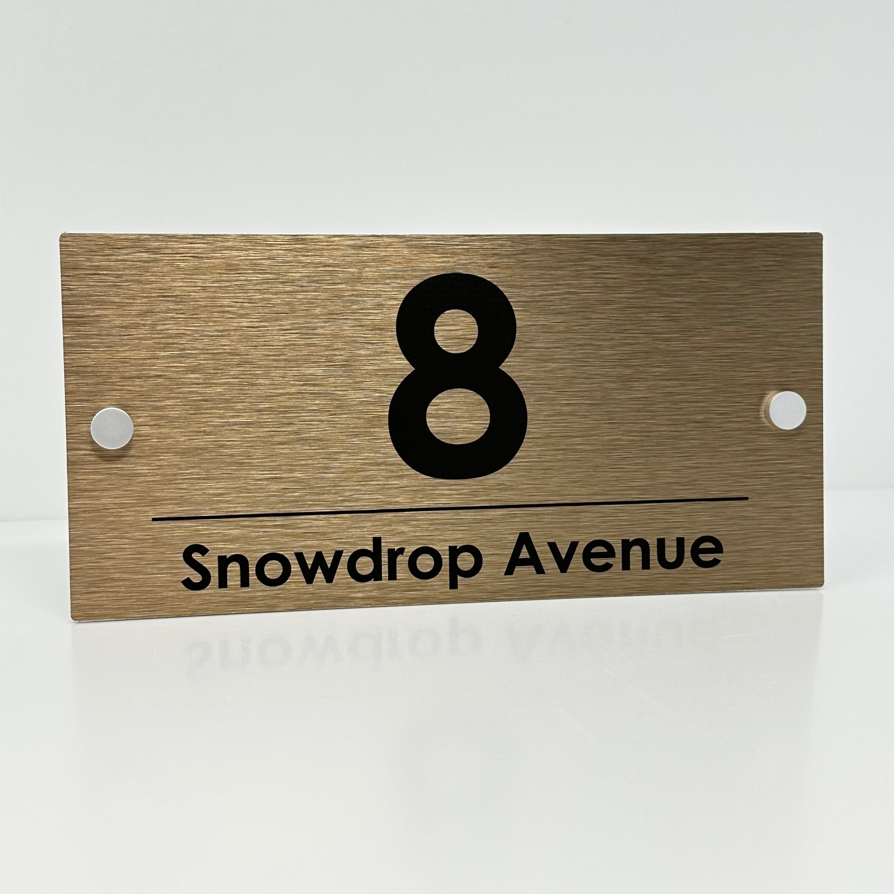 The Snowdrop Modern House Sign with a Brushed Brass Panel and Satin Silver Stand Off Fixings ( Size - 25cm x 12cm )