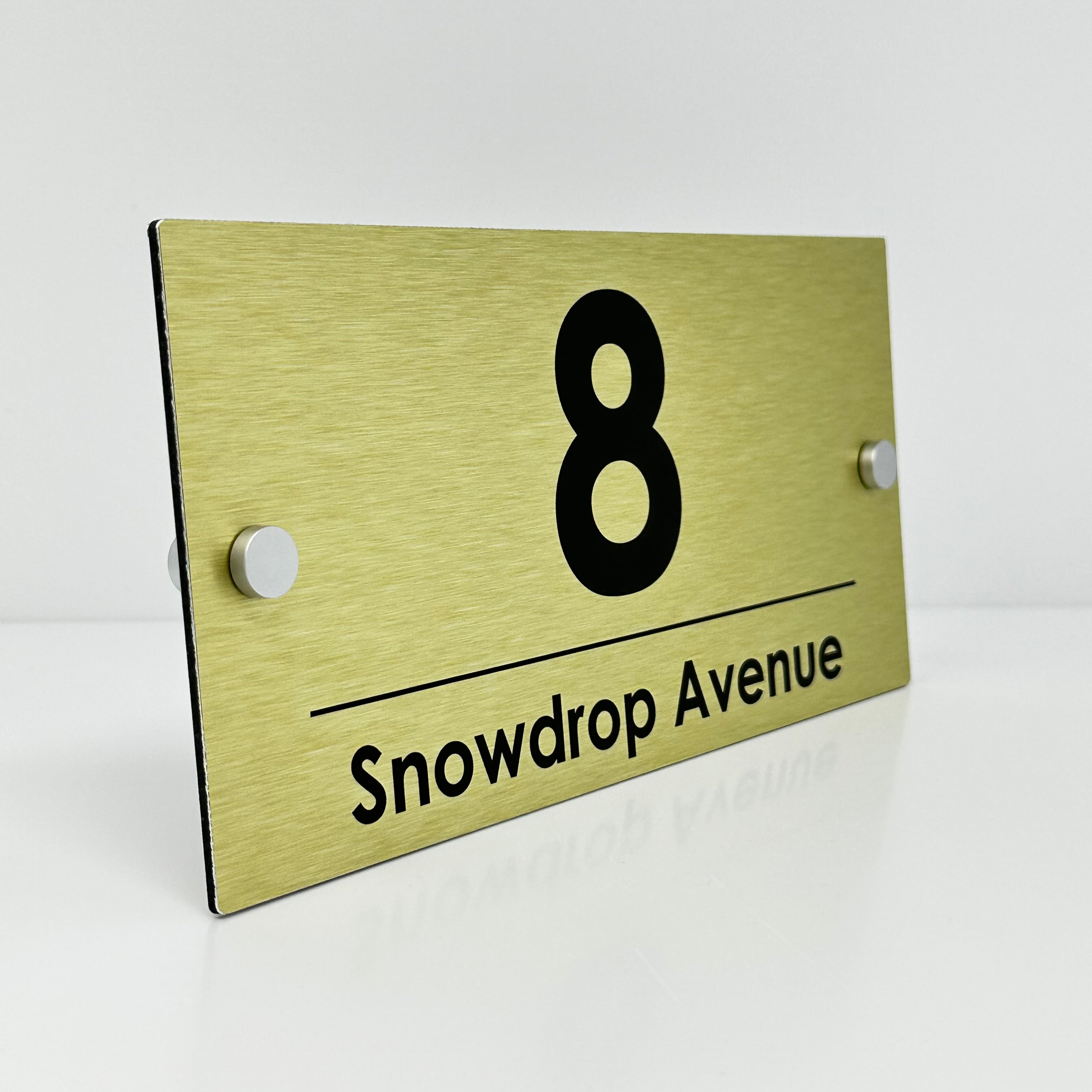 The Snowdrop Modern House Sign with a Brushed Gold Panel and Satin Silver Stand Off Fixings ( Size - 25cm x 12cm )