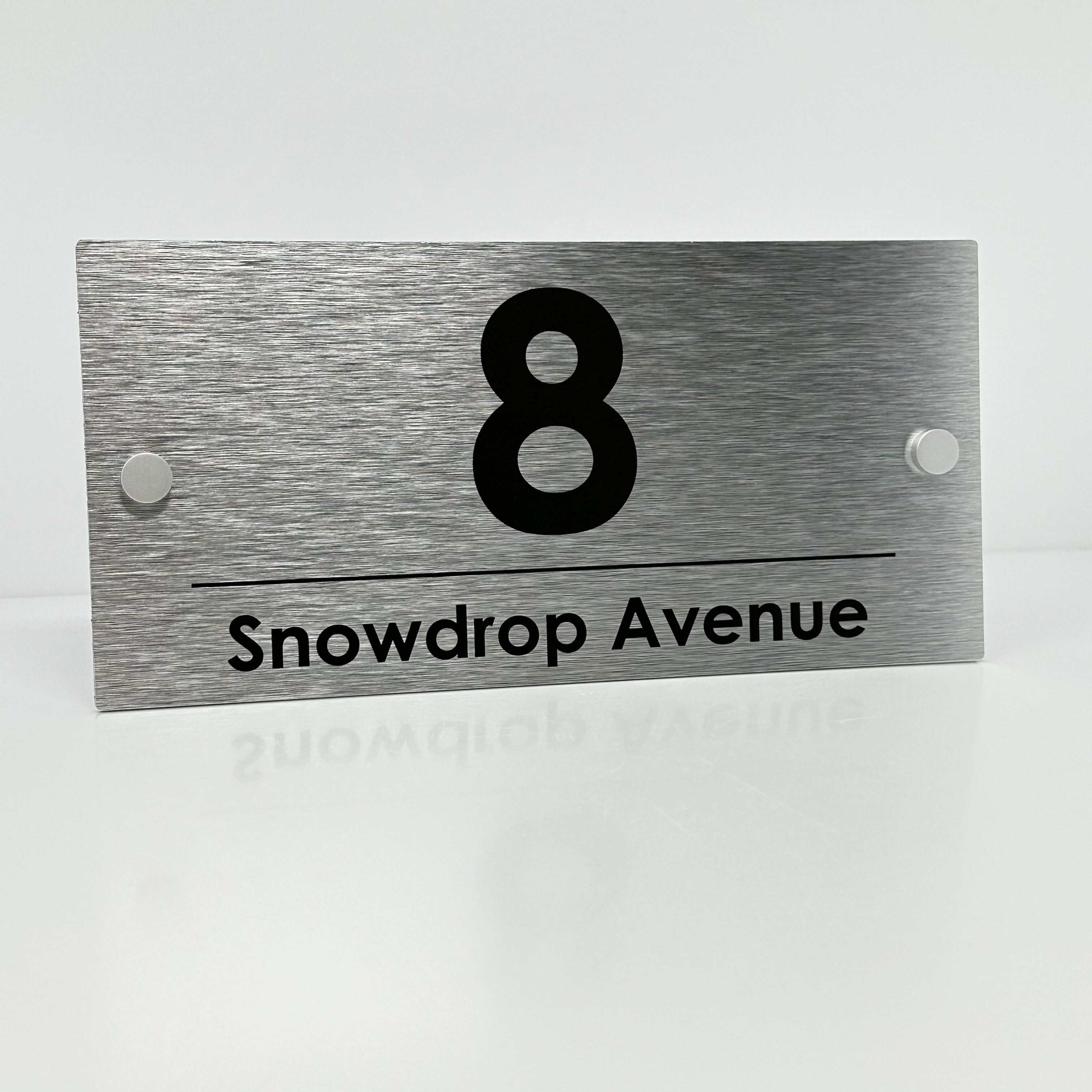 The Snowdrop Modern House Sign with a Brushed Silver Panel and Satin Silver Stand Off Fixings ( Size - 25cm x 12cm )